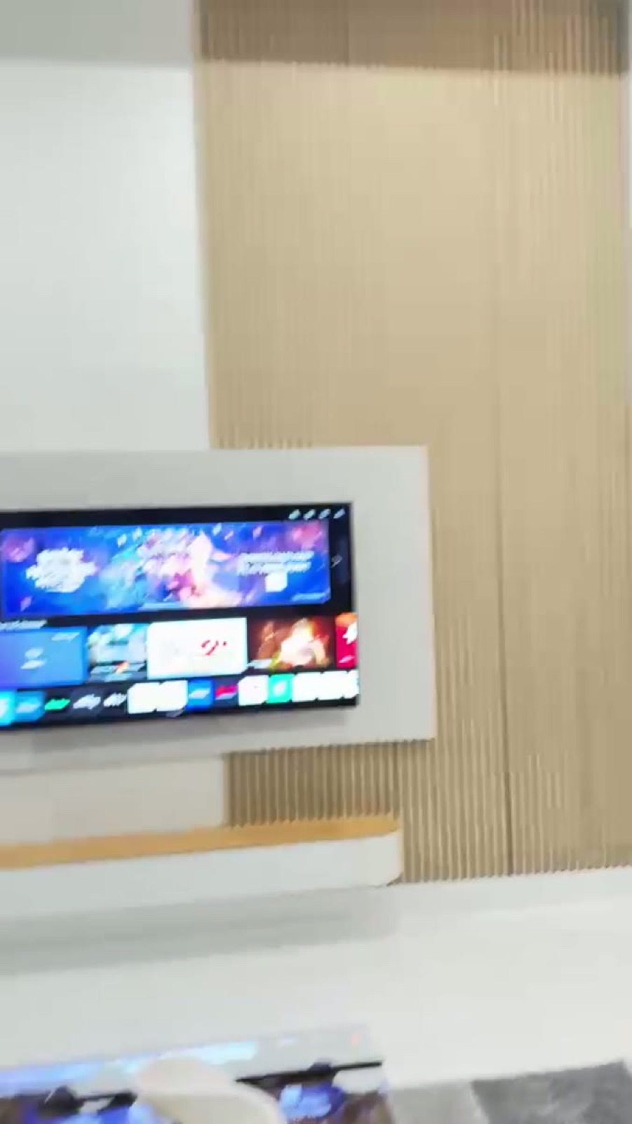 Wood slat wall with a floating TV