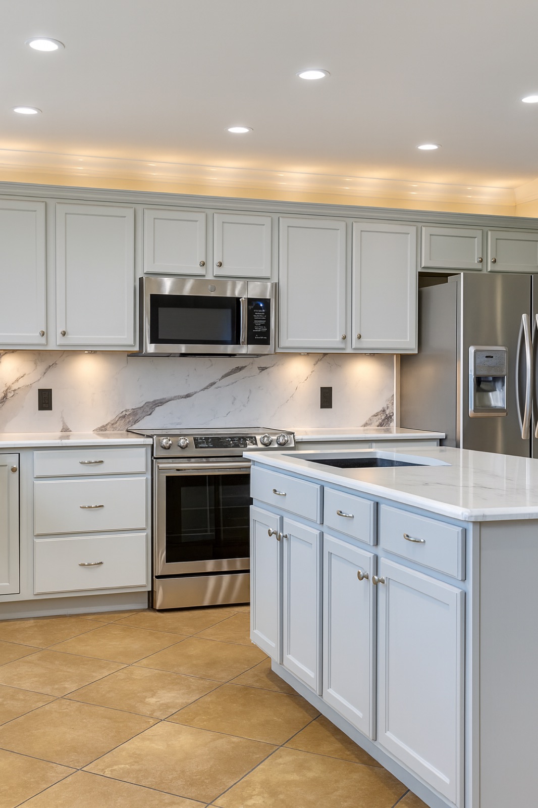 White kitchen with marble backsplash and LED lighting